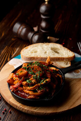 Beef potato stew, baked in a cast-iron stew with greens, atmospheric photo for a food magazine