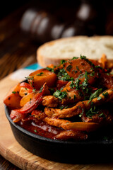 Beef potato stew, baked in a cast-iron stew with greens, atmospheric photo for a food magazine