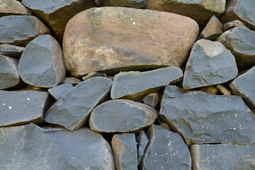 antique masonry made of hewn stones of gray-brown color and different shapes