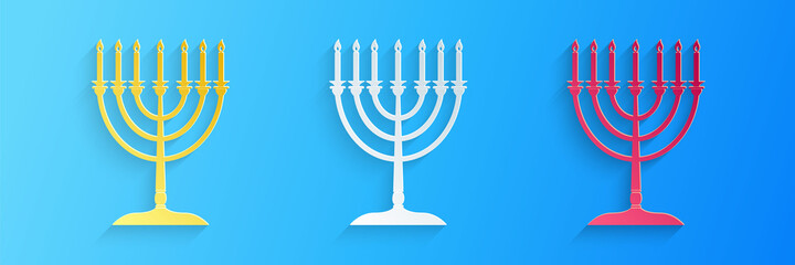 Paper cut Hanukkah menorah icon isolated on blue background. Religion icon. Hanukkah traditional symbol. Holiday religion, jewish festival of Lights. Paper art style. Vector.