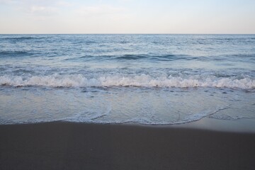 Sea beach with blue sky and yellow sand and some clouds