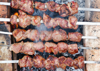 Delicious grilled pork meat in BBQ Barbecue with pork meat. Kebabs on the grill. Close-Up Of Meat On Barbecue Grill With Smoke.
