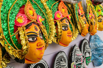 Colorful chhou masks of Hindu Goddess Durga, on display for sale at handicrafts fair, Kolkata, West Bengal, India.