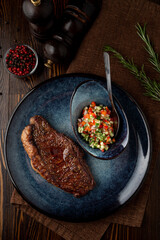Medium-rare loin in a dark steak house, top view