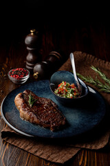 Medium-rare loin in a dark steak house, top view