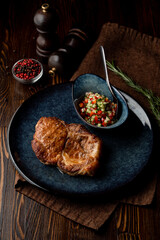 Roasted greasy pork steak, dark atmospheric photo for a food magazine