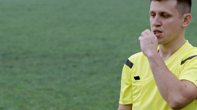 Referee goes watching VAR or violation of the rules and shows a penalty, yellow or red card . Concept of sport, rules violation, offside