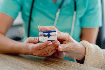 Doctor using pulse oximeter on woman