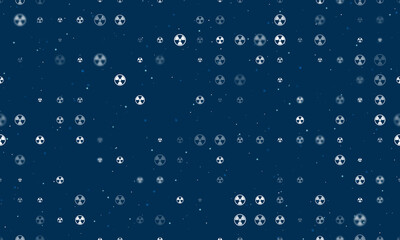 Seamless background pattern of evenly spaced white radiation symbols of different sizes and opacity. Vector illustration on dark blue background with stars