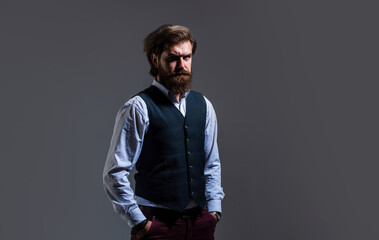 Fototapeta premium handsome and successful man in expensive suit. He is in shirt. stylish successful man in suit posing. business man wear suit. official office lifestyle. serious bearded man