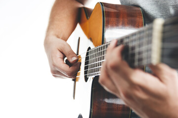 Close up of human's hands playing flamenco guitar. Musical instrument for recreation or hobby passion concept. Selective focus.