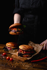 Man in a black uni holding a fatburger, beautiful magazine photo