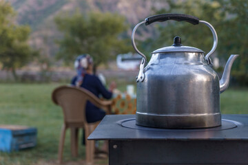 A traditional Turkish teapod on stove. Silver teapot used to brew tea.