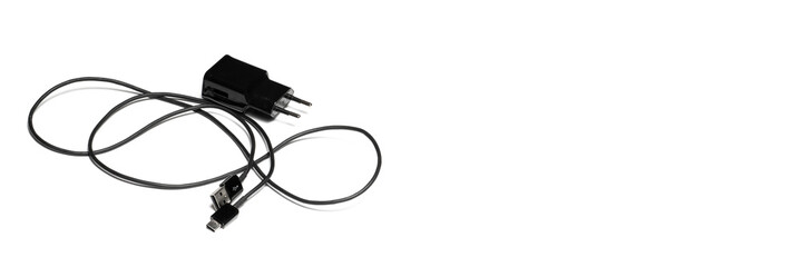 Black phone charging cable on isolated white background. Banner panoramic. Copy space for text...