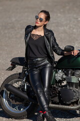 Plakat woman in black with a motorcycle