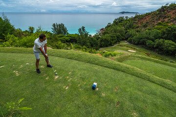 Tropical Golf course hole nr. 15 Lemuria Resort Praslin Seychelles  golfer tee shot Anse Georgette  