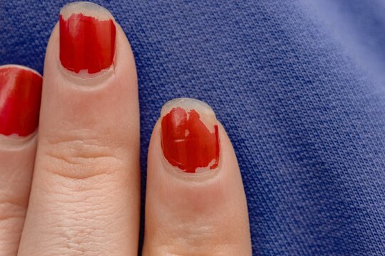 Chipped Red Nail Polish. Dry Nails. 