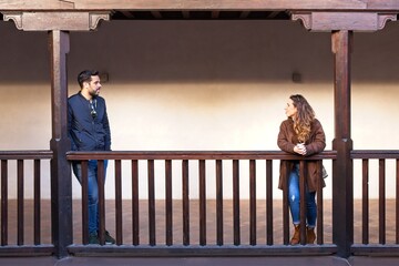 Young couple on a wooden balcony in the Real Alcazar in Seville Spain