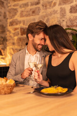 Lifestyle, a young European couple in love having dinner in a beautiful restaurant, celebrating Valentine's Day