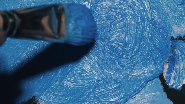 Artist copyist paint seascape with ship in ocean. Craftsman decorator draw as boat sail on blue sea with acrylic oil color. Draw finger, brush, knife palette. Indoor. Close up cinematic look.