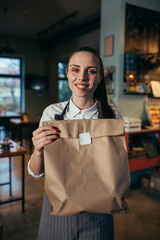 waitress holding prepared takeaway food in eatery. food delivery concept. coronavirus quarantine concept