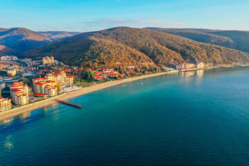 Bulgaria, no tourists, empty beach. Black Sea cost in low season. Hotel buildings, mountains, autumn.