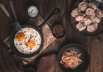 Lunch on a vintage background with scrambled eggs, dumplings and cabbage.