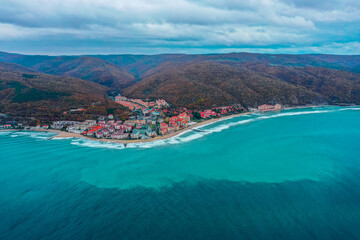 Bulgaria, no tourists, empty beach. Black Sea cost in low season. Hotel buildings, mountains, autumn.