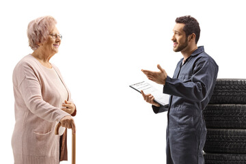 Young auto mechanic talking to an elderly woman