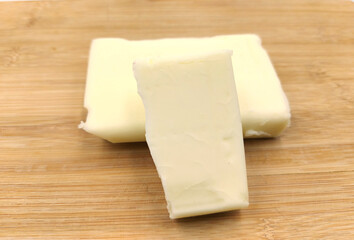 cheese on wooden board, dairy (makkhan) product on wooden table
