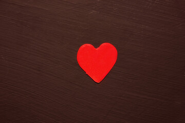 Red heart on a black background. View from above. Hearts are in the middle. The concept of Love. Valentine is Day. Romance. Background. Texture. Copy space. Flatlay.