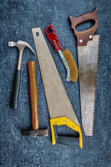 Vintage carpentry tools on an grungy gray background, handwork concept, flat lay