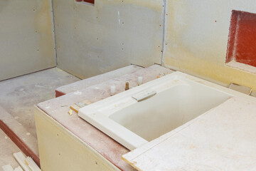 House under construction bathroom with drywall and patching ready for tile installation close up
