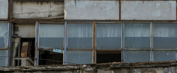 abandoned factory warehouse with broken windows