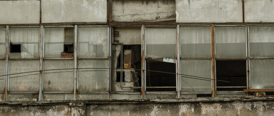 abandoned factory warehouse with broken windows