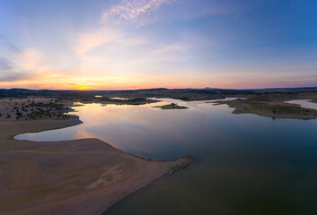 Fototapeta premium Drone aerial panorama of a dam lake reservoir at sunset in Terena, Portugal