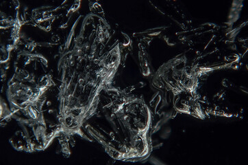 ice crystals on glass on a dark background. Close-up macro