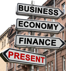 The road indicator on the arrows of which is written - business, economics, finance and PRESENT