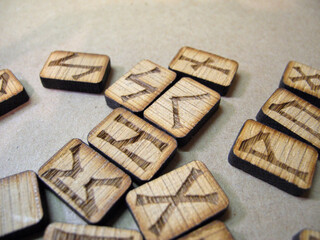 Homemade Scandinavian runes for divination. The runes say: wealth, fire, chaos, travel, knowledge, air, joy, duty, ice.