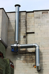 metal pipe for supply and exhaust ventilation goes outside the house. the built-in motor runs inside