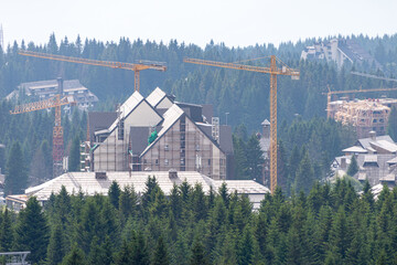 Fototapeta na wymiar Apartments buildings under construction in a ski resort in summer