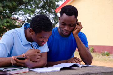 african student studying their books