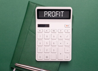 Profit word inscription on calculator on green desk