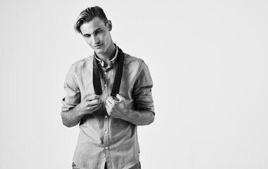 Sexy guy in shirt on isolated background cropped black and white photo view