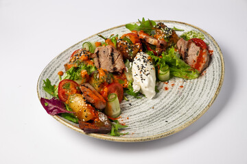 Salad with pork and pumpkin, on a white background