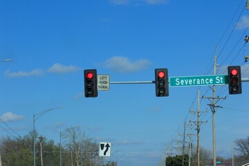 traffic light in the city in Hutchinson Kansas USA with blue sky and clouds.