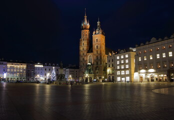 Fototapeta na wymiar Krakow night cityscape, main market square, saint marys church, christmas tree, empty, without people
