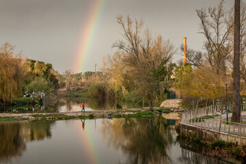 Rainbow reflected in the water in the city park of Tomar, an ancient templar city located in Portugal