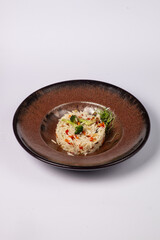 Basmati rice with fried carrots, onions, mushrooms, broccoli vegetables in butter on a white background