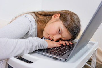 Portrait of attractive cute girl was tired and fell asleep on the laptop after distance learning